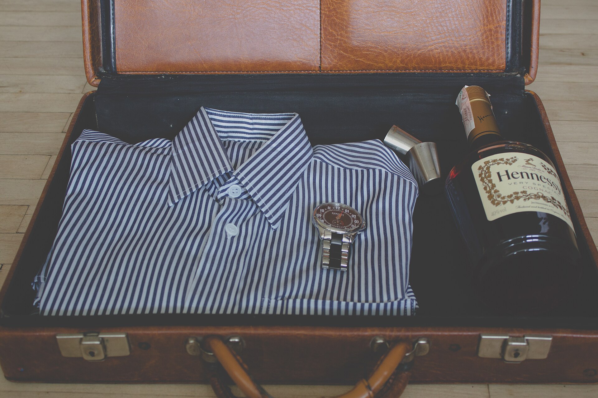 Traveller packing essentials into a suitcase for a business trip