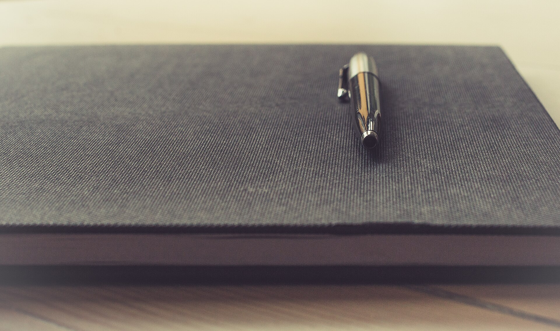 Pen resting on an open notebook for a short journal entry