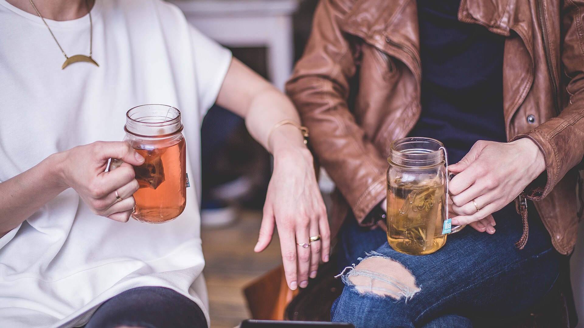 Friends sharing a conversation over cups of tea