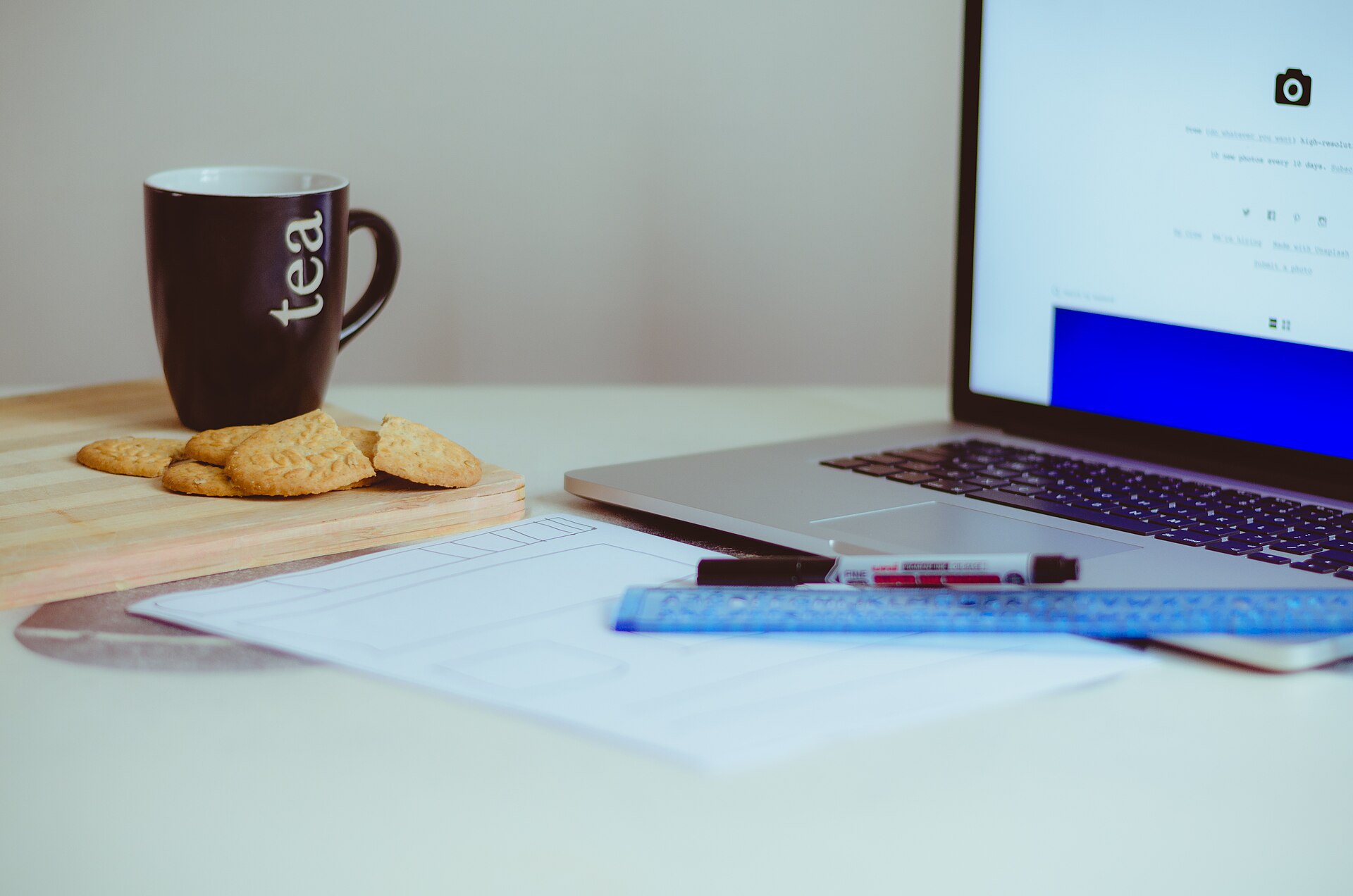 Cup of tea beside a laptop during a mindful work break